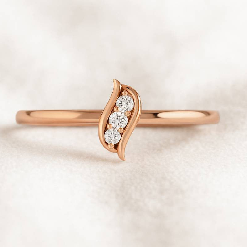 Rose gold ring with diamonds on a light beige background