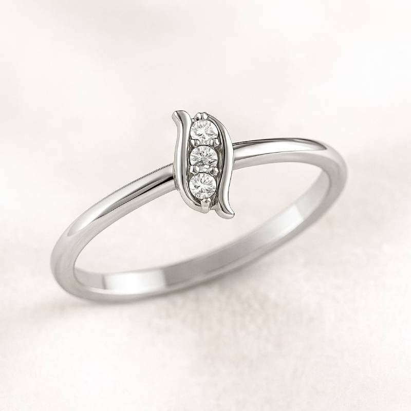 Gold ring with small diamonds on a light beige background