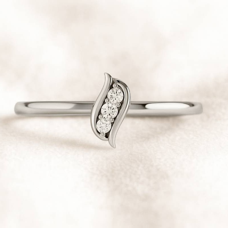 Gold ring with diamond accents on a light pink background