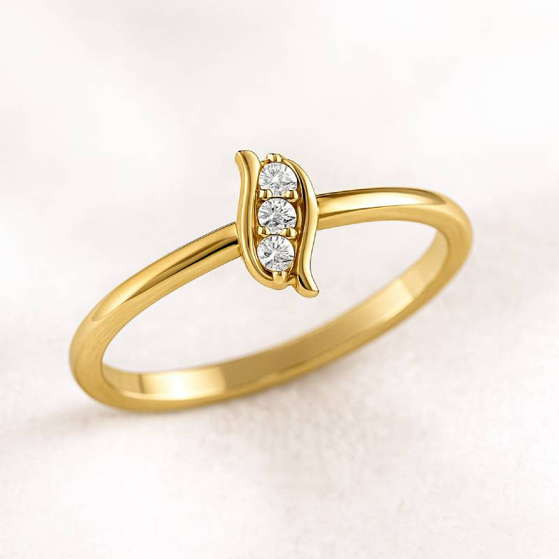Gold ring with small diamonds on a light pink background
