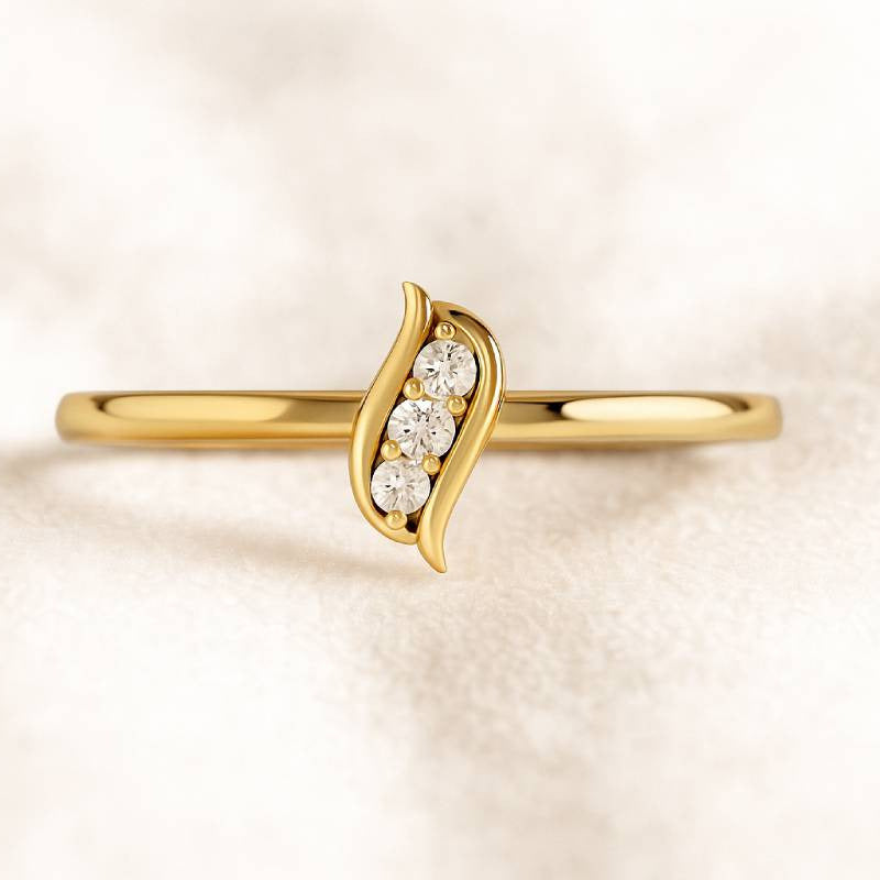Gold ring with small diamonds on a light beige background