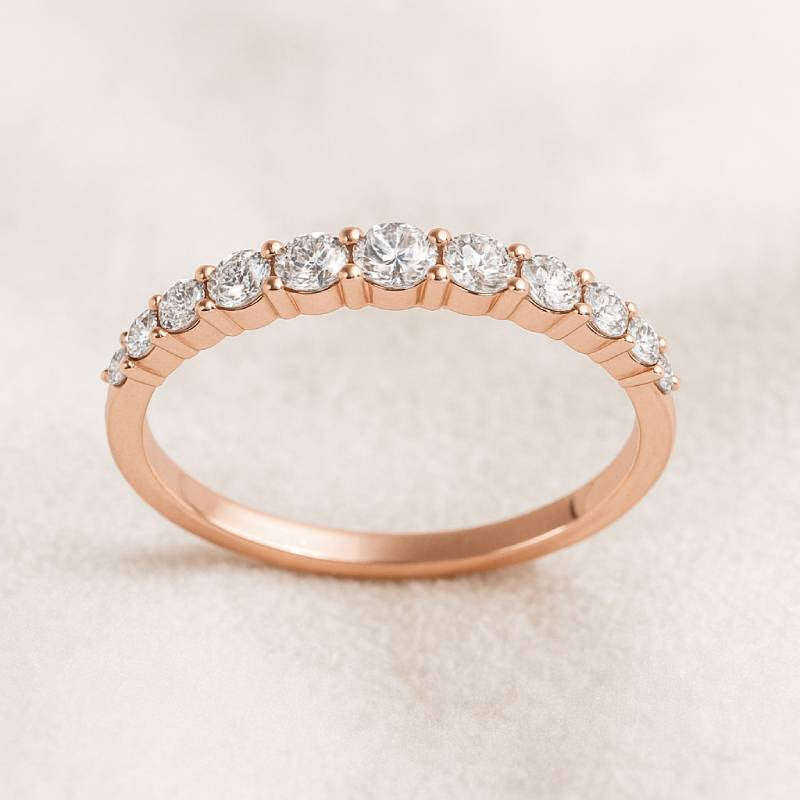 Rose gold ring with diamonds on a light beige background