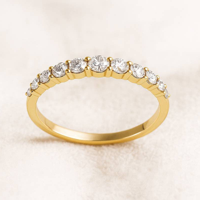 Gold ring with diamonds on a beige background