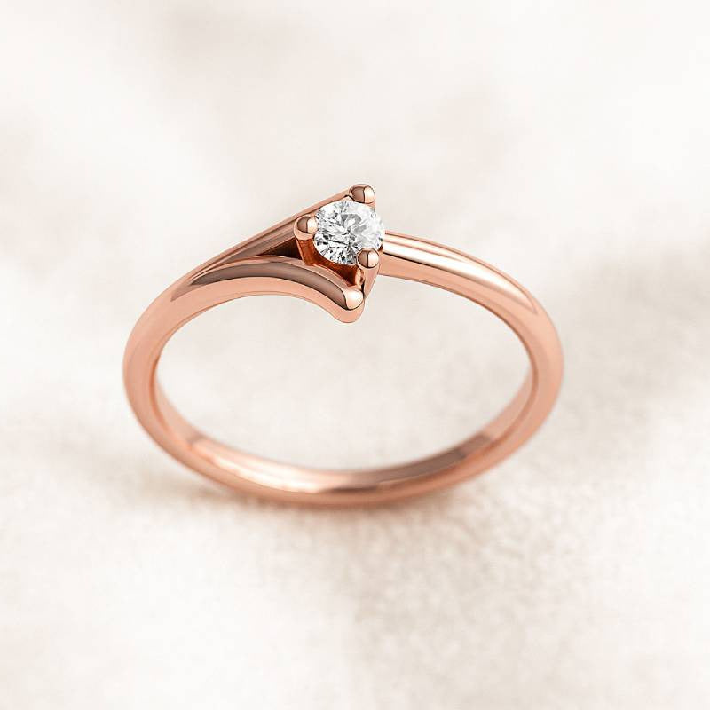 Rose gold ring with a diamond on a light beige background