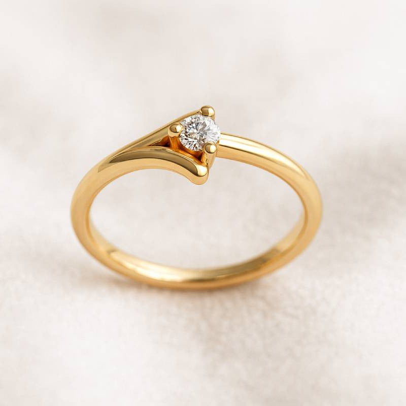 Gold ring with a diamond on a beige background
