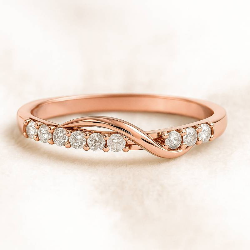 Rose gold ring with diamonds on a light beige background