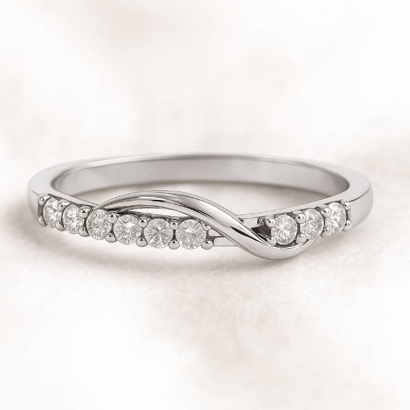 Gold ring with diamonds on a light pink background
