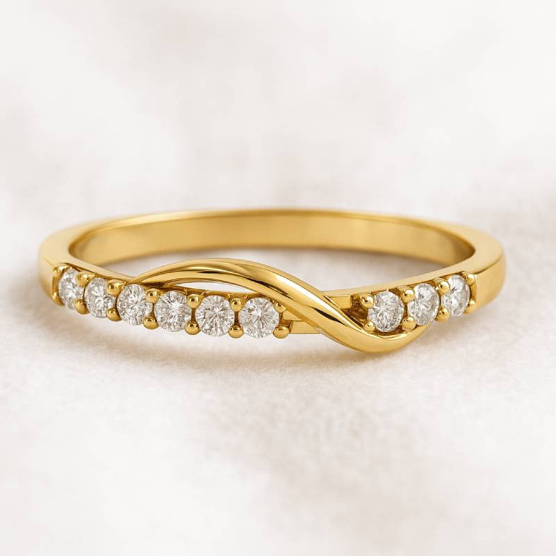 Gold ring with diamonds on a light background