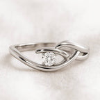 Gold ring with a diamond on a light background