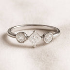  ring with three diamonds on a light background