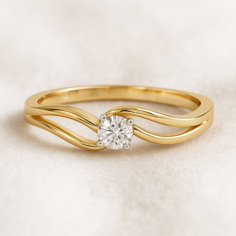 Gold ring with a diamond on a light beige background