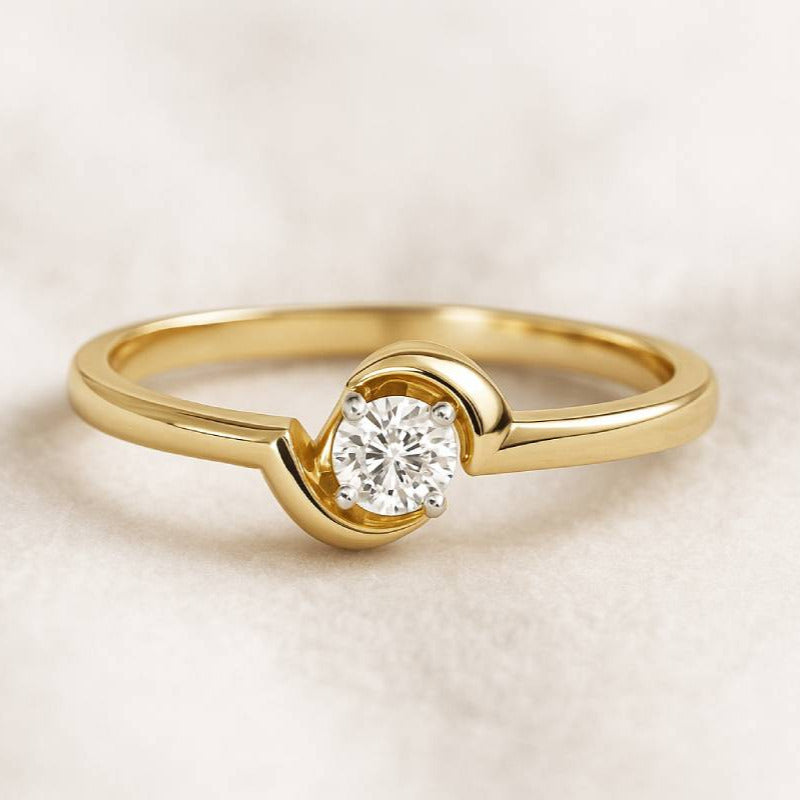 Gold ring with a diamond on a light beige background