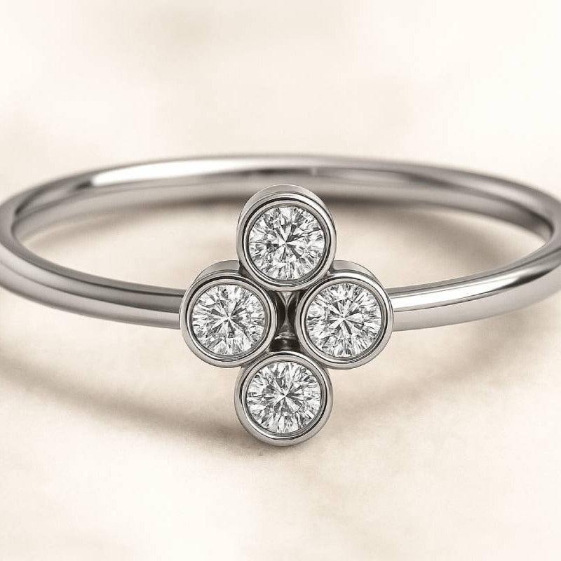 ring with four diamond-like gemstones on a beige background