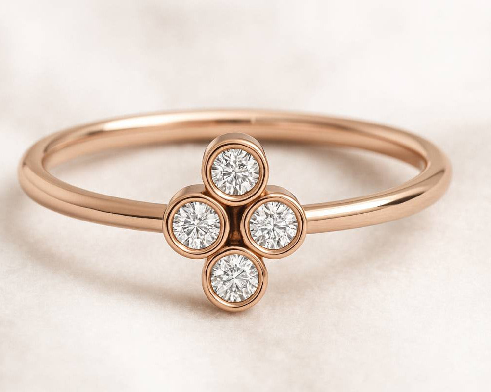 Rose gold ring with diamond cluster on a light background