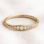 Gold ring with diamonds on a light background