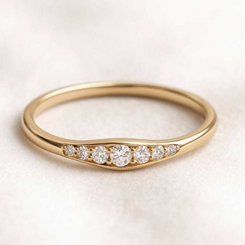 Gold ring with diamonds on a light background
