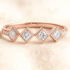 Rose gold ring with diamond stones on a soft beige background