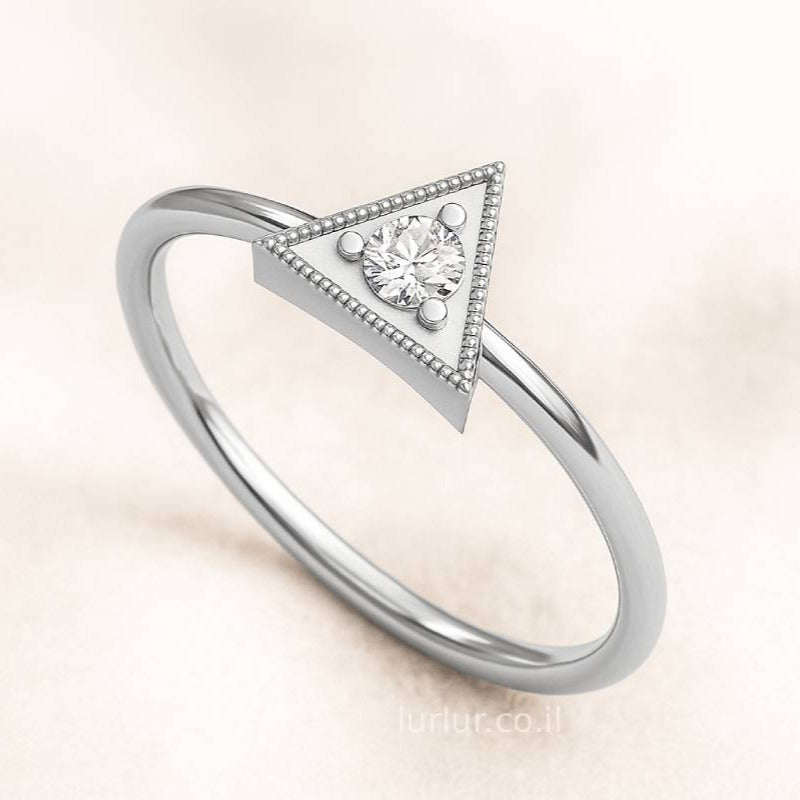  ring with a triangle design and central gemstone on a light background