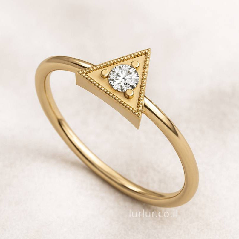 Gold ring with a diamond on a light background