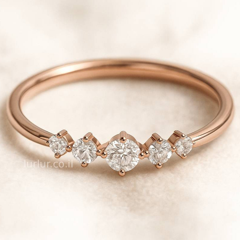 Rose gold ring with diamonds on a light background