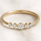 Gold ring with diamonds on a light background