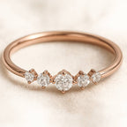 Rose gold ring with diamonds on a light background