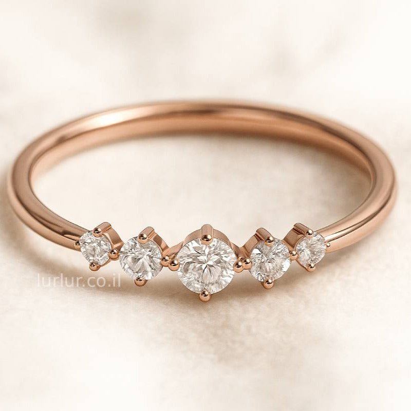 Rose gold ring with diamonds on a light background