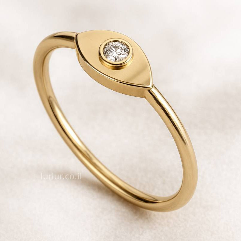 Gold ring with a diamond on a light beige background