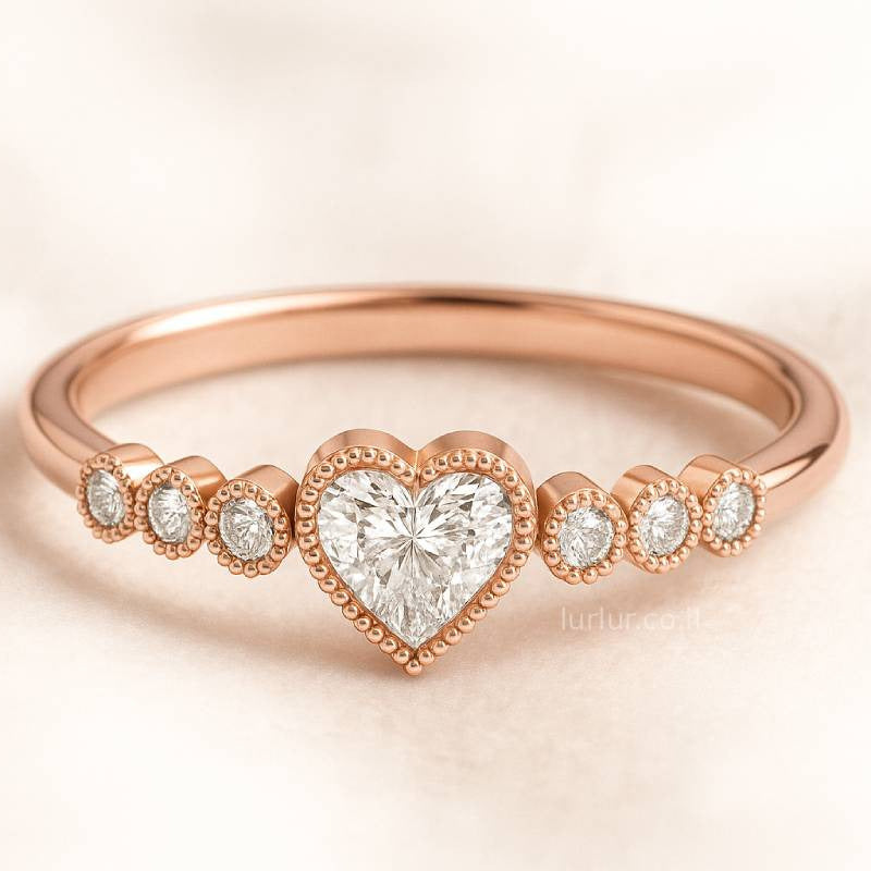 Rose gold ring with heart-shaped diamond on a light background