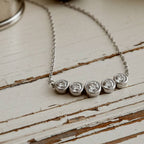 Gold necklace with five round diamonds 