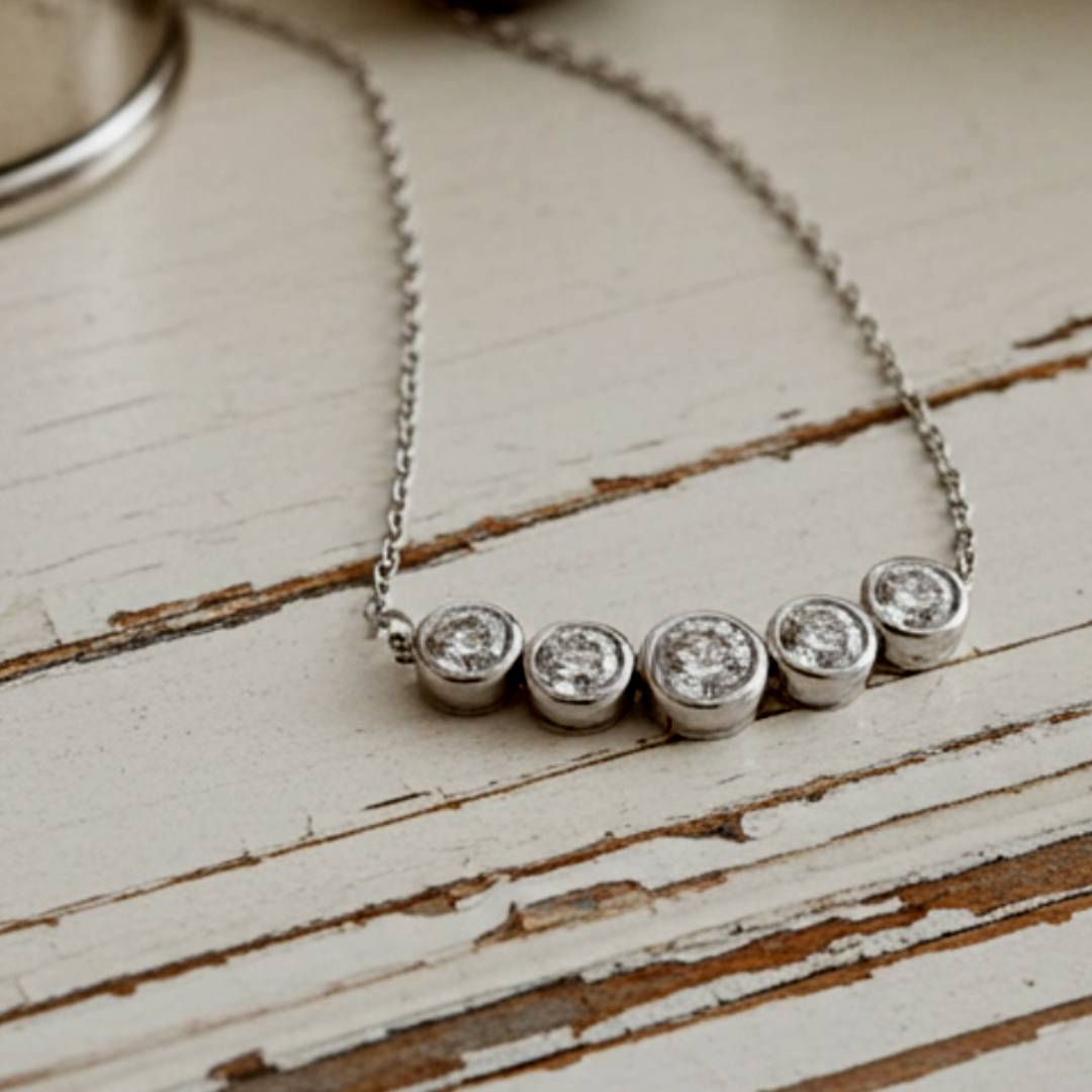 Gold necklace with five round diamonds 