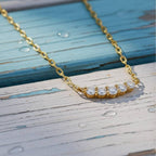 Gold necklace with diamonds on wood background