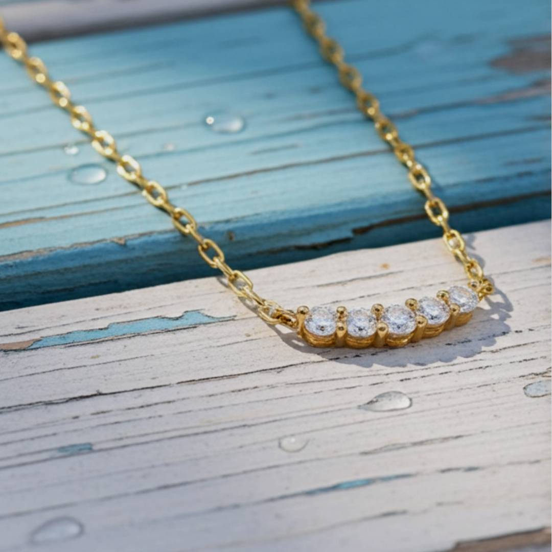 Gold necklace with diamonds on wood background