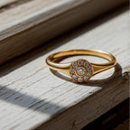 Gold ring with small diamonds on a wood background
