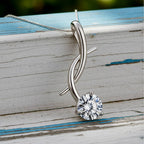 Gold pendant with a diamond on a wood background
