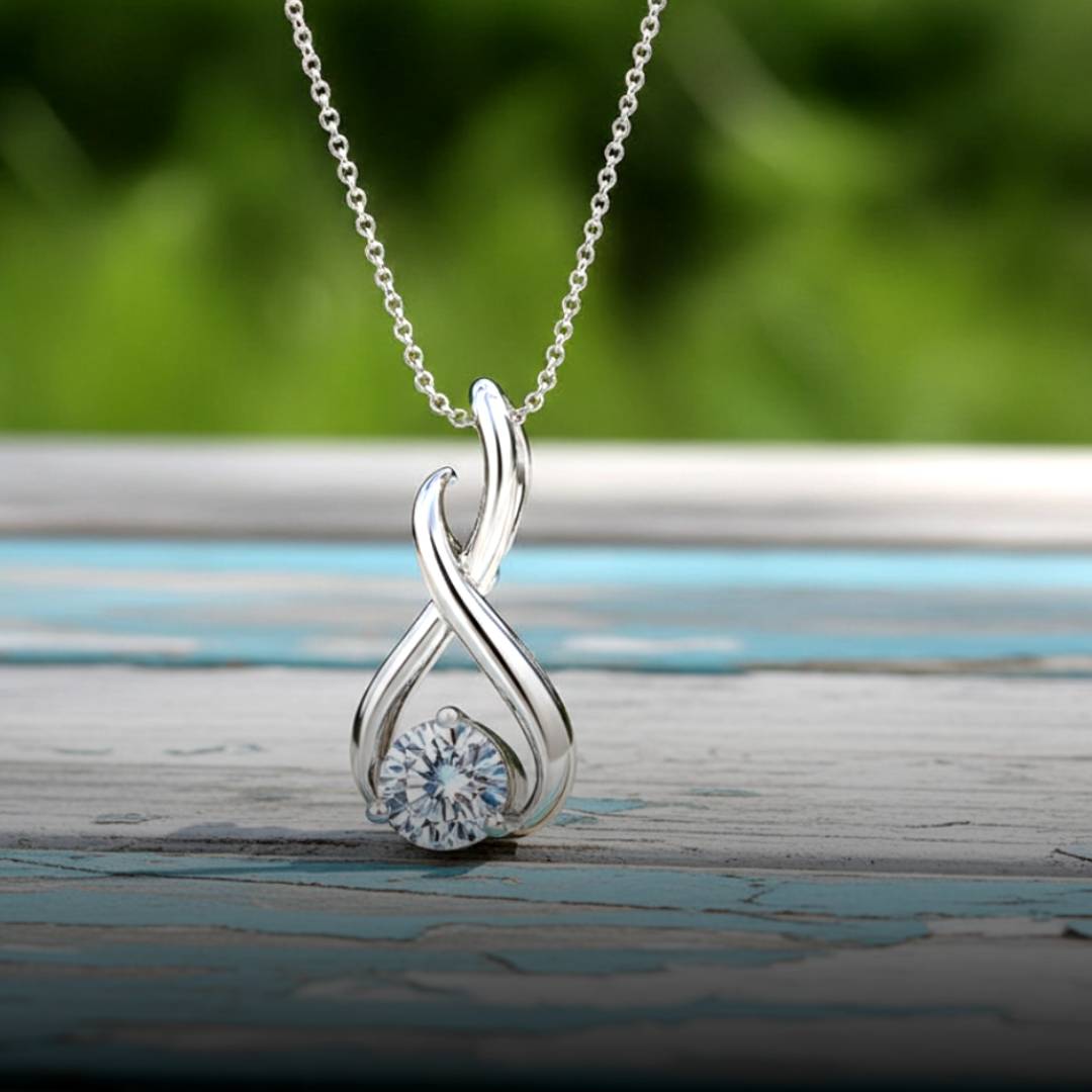 Gold infinity pendant with a diamond wood background