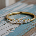ring with small diamonds on a wood background
