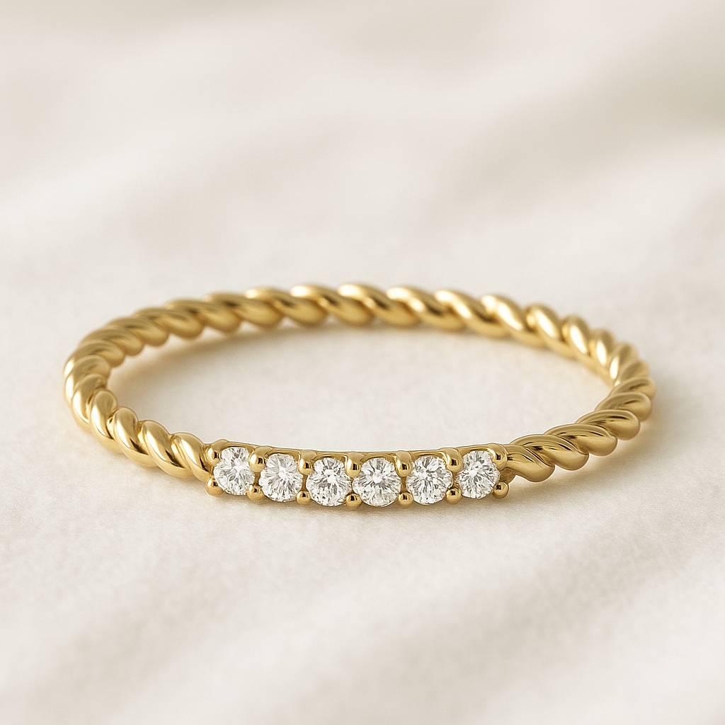 Gold ring with diamond stones on a light background