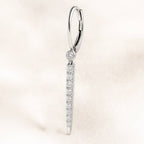 Diamond earring on a light pink background