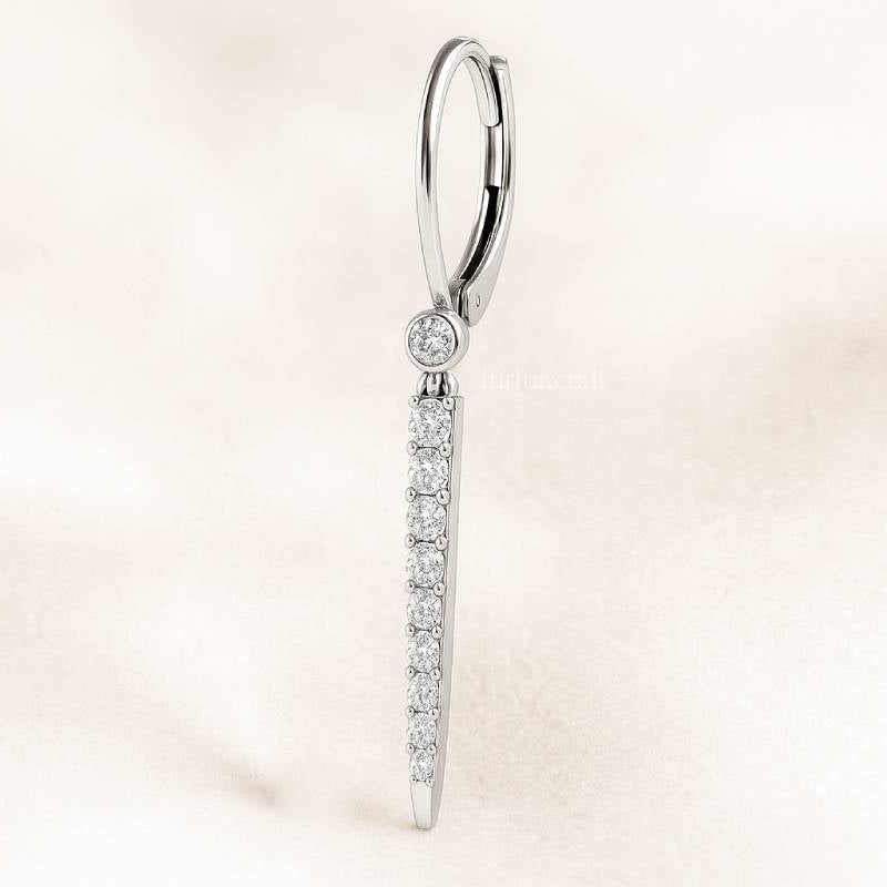 Diamond earring on a light pink background